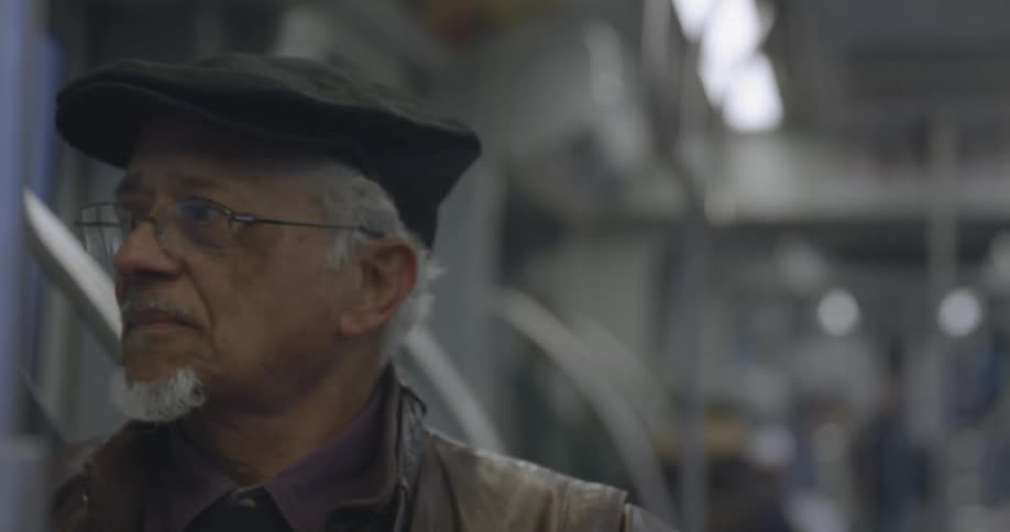 Elderly man riding a subway