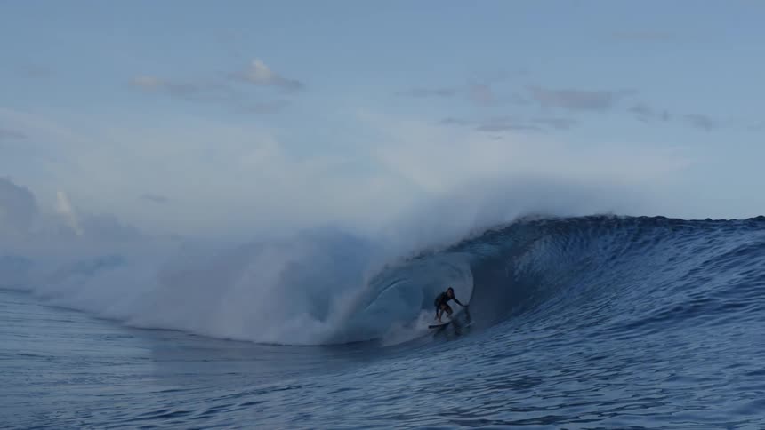 A man is riding a wave