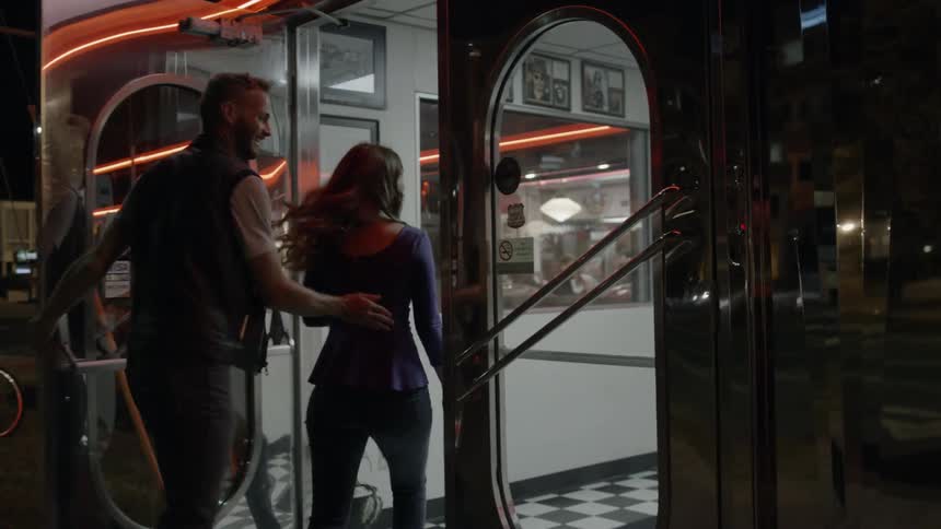 A couple enter a diner together