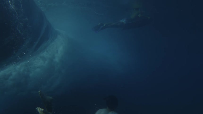 Two men dive underwater