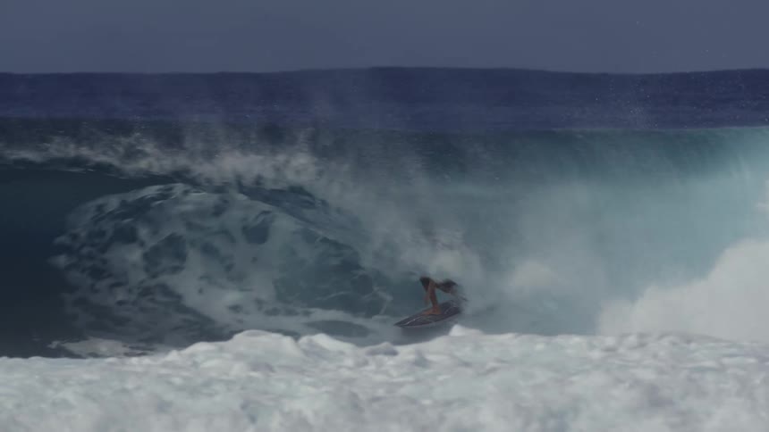 Young man surfing inside a wave