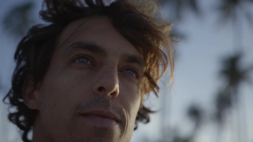Portrait of a man in an outdoor setting with palm trees