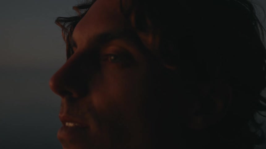 A man is looking around at sunset
