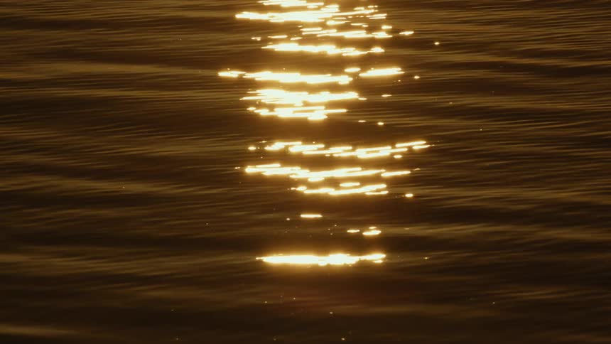 Moving sea with the sunlight reflection from the rising sun