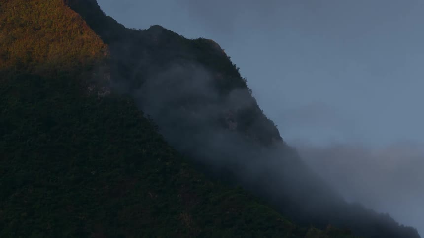 Mountainside in the mist at dusk