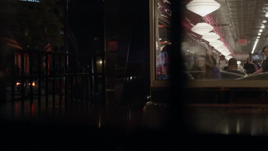 People are inside a diner eating and walking
