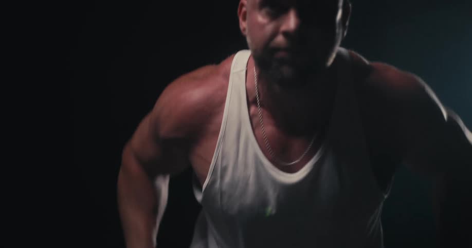 Man exercises by lifting weights