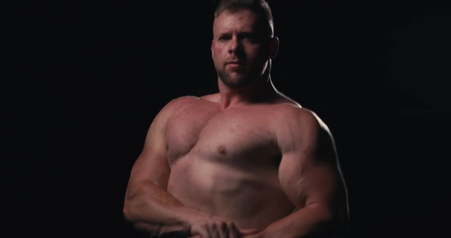 Man striking a bodybuilder pose with his arms
