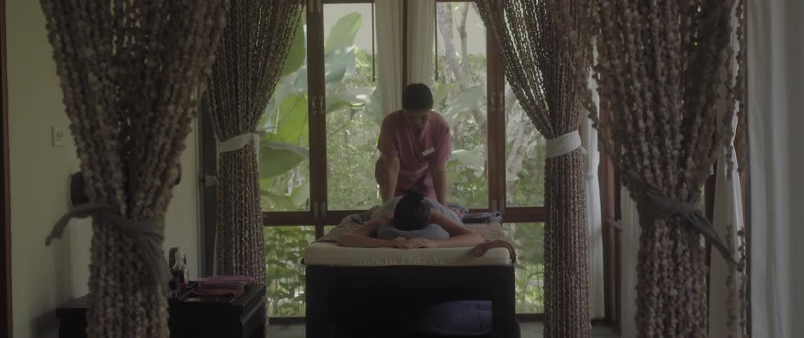 Woman receiving a body massage in an indoor spa setting