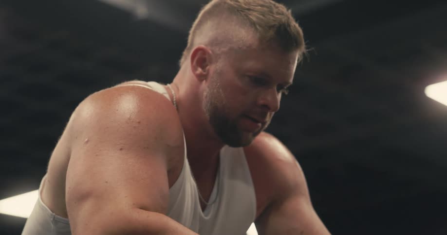 Bodybuilder sitting and taking a deep breath
