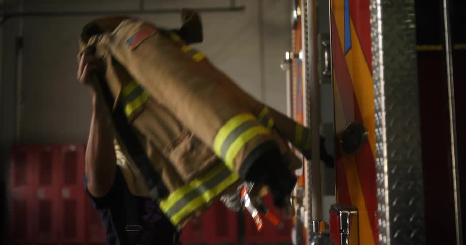 Firefighter grabbing his work coat