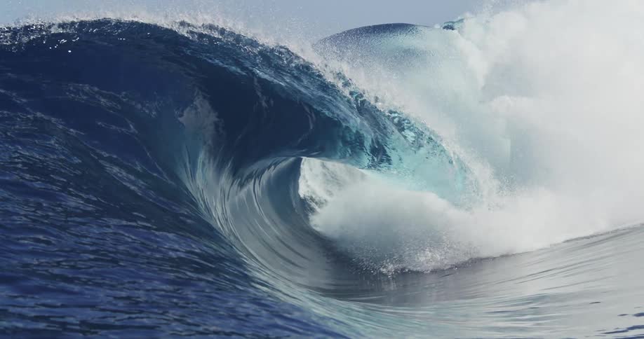 A large wave crashes in the ocean