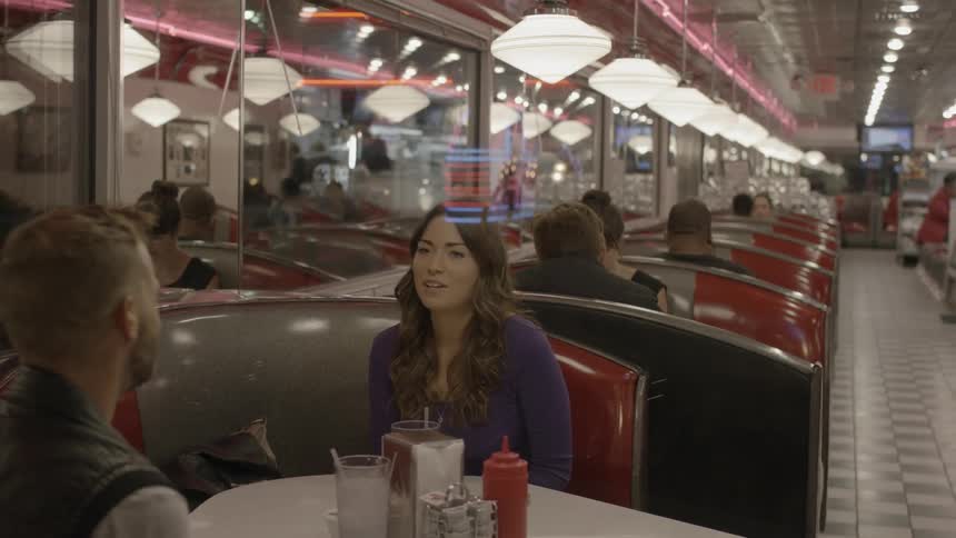 Couple sitting and talking in a diner