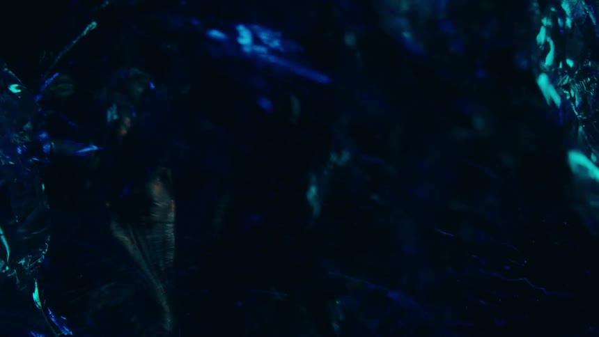 Abstract and crystalline object in motion with bright blue coloring