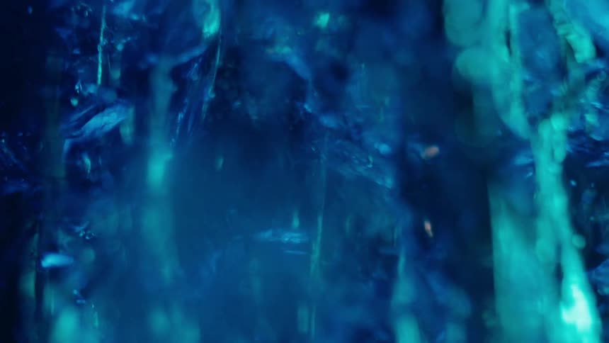 Abstract blue object breaking and generating liquid bubbles