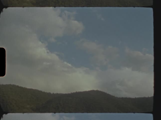 View of a mountain with passing clouds in time lapse