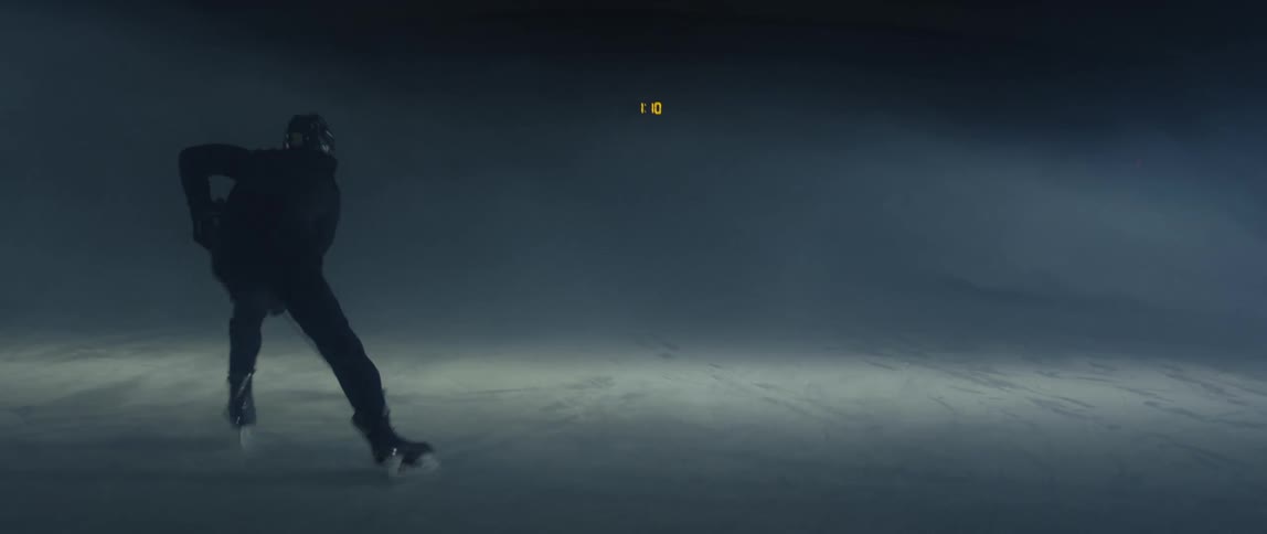 Silhouette of a man skating on a hockey rink surrounded in mist
