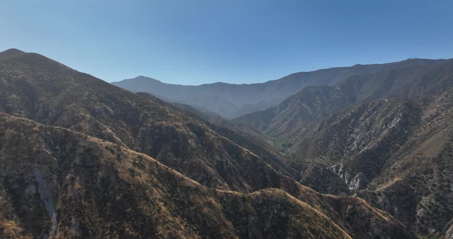 The sky is clear over the mountains
