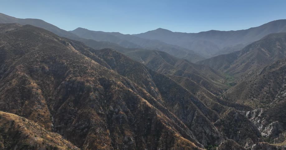 Aerial view of nature with a mountain range on a clear cloudless day