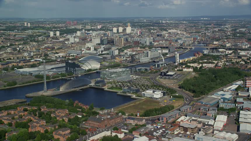 A river runs past neighborhoods in a dense city
