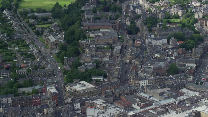 Aerial view of a city amidst a lush and green countryside