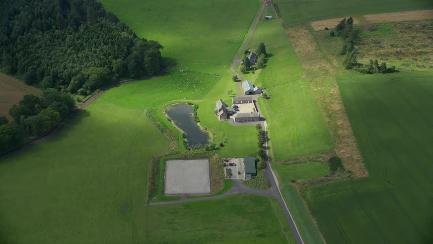 Aerial view of a rural area with some houses and a lake in a natural environment