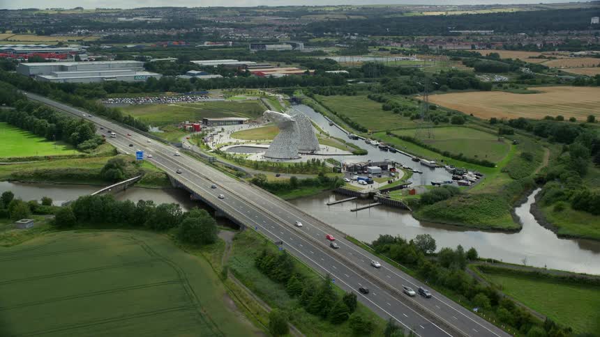 Aerial view of cars driving on highway near the kelpies sculpture
