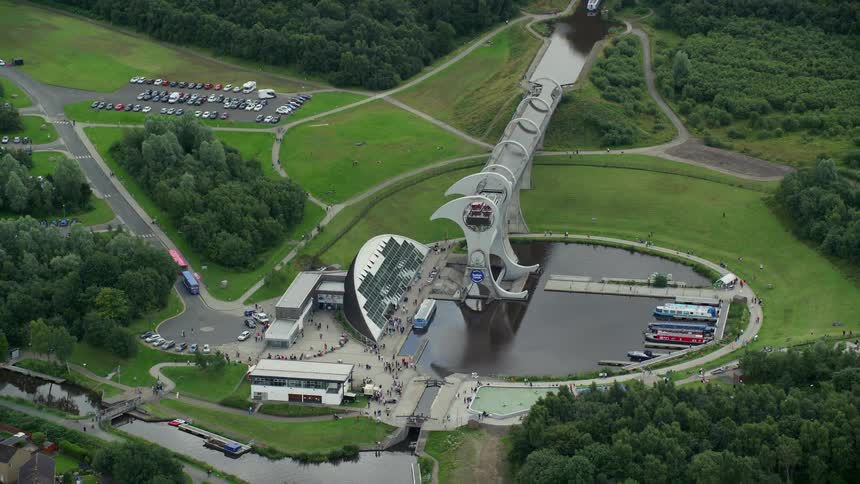 Aerial of an architectural buildings and dam with boats parked in the marina