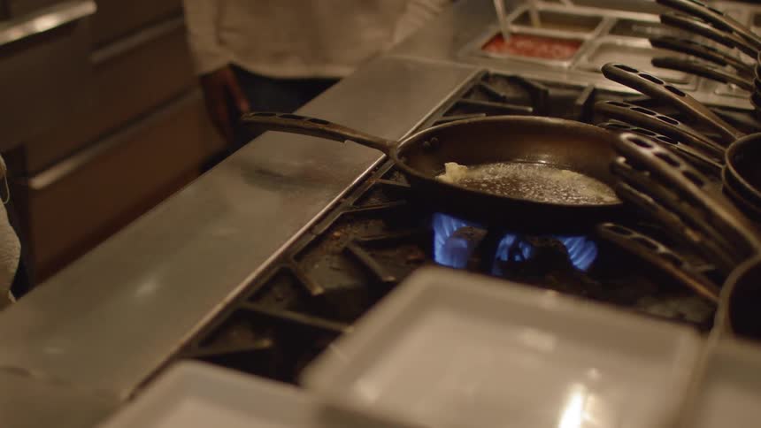 Butter melting in a frying pan in a restaurant