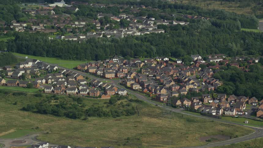 Aerial of a rural town with a highway and small houses