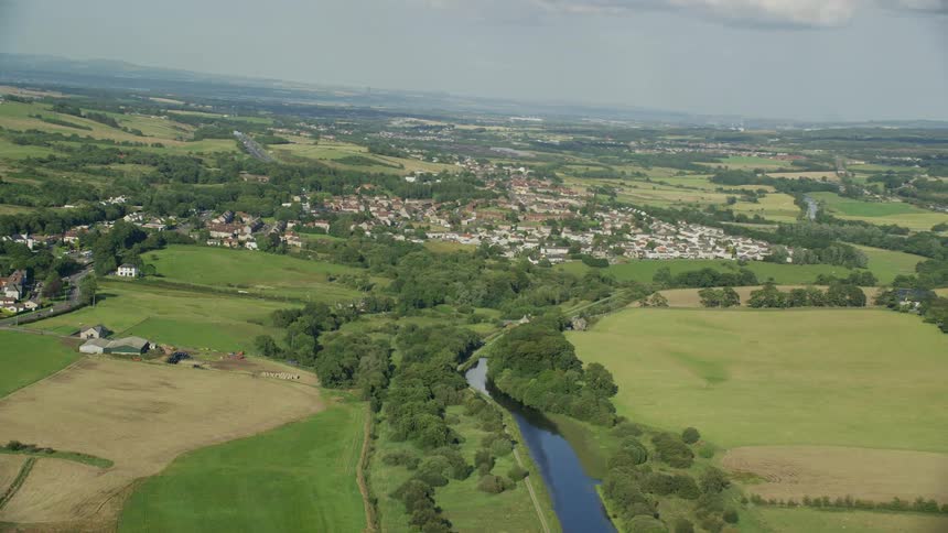 Aerial view of a rural area with some residences and a small central river