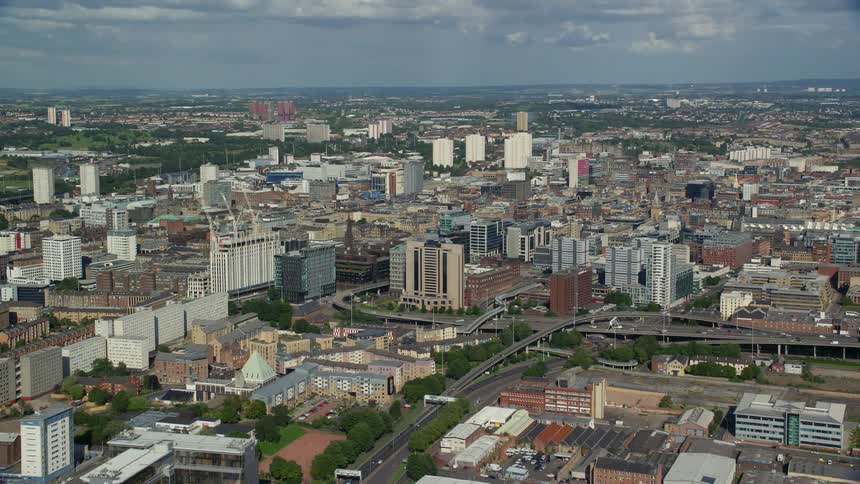 Aerial view of a metropolitan city with highways buildings and a stadium