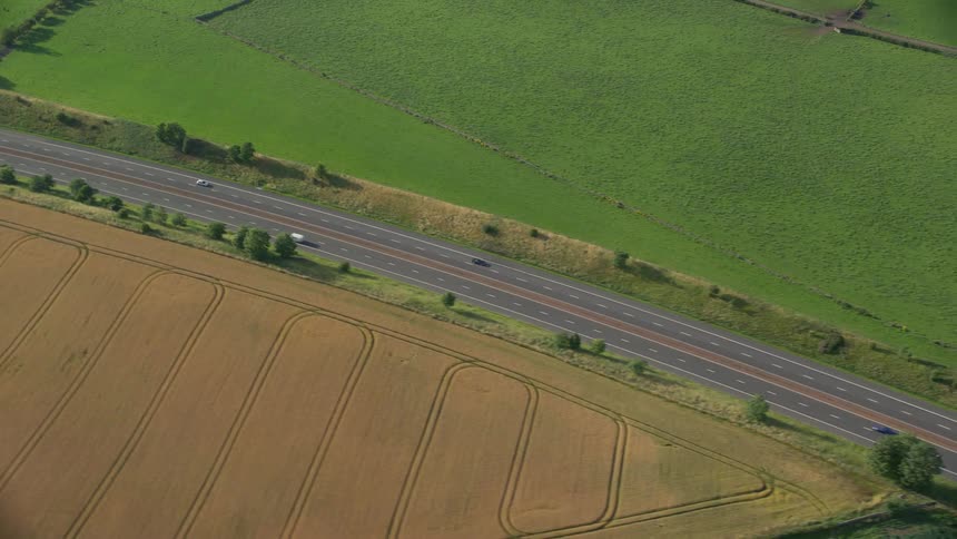 Aerial view of a rural area and a road with vehicles moving