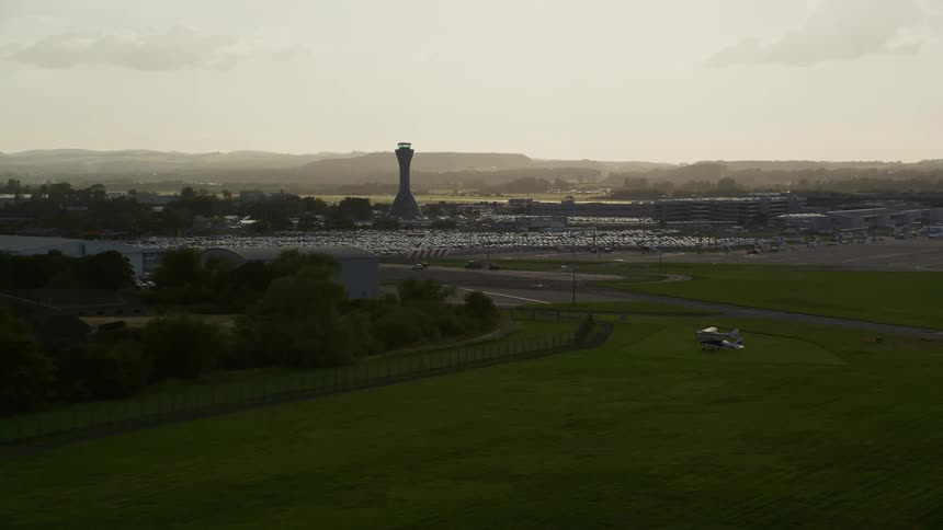 Aerial view of fields with private planes and parked cars