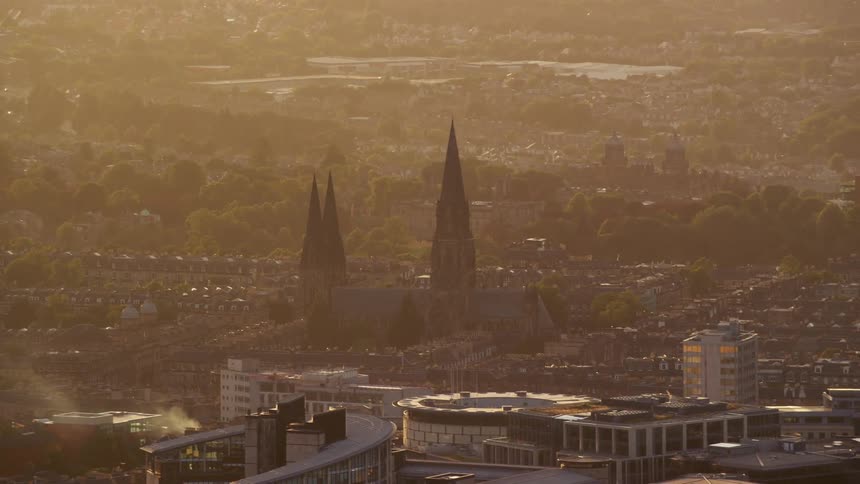 Aerial view of the towers of a church or cathedral in the city at sunset