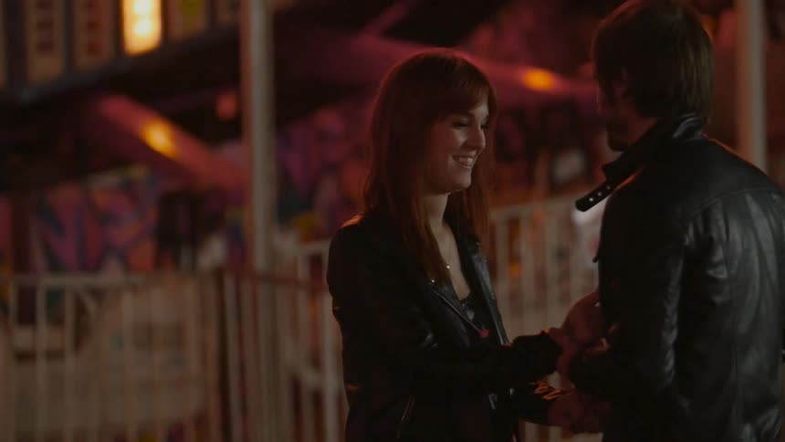 A man and woman talk together at a carnival