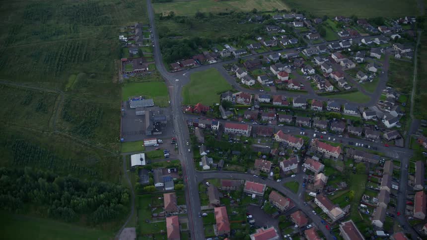 A village of homes surrounded by green fields