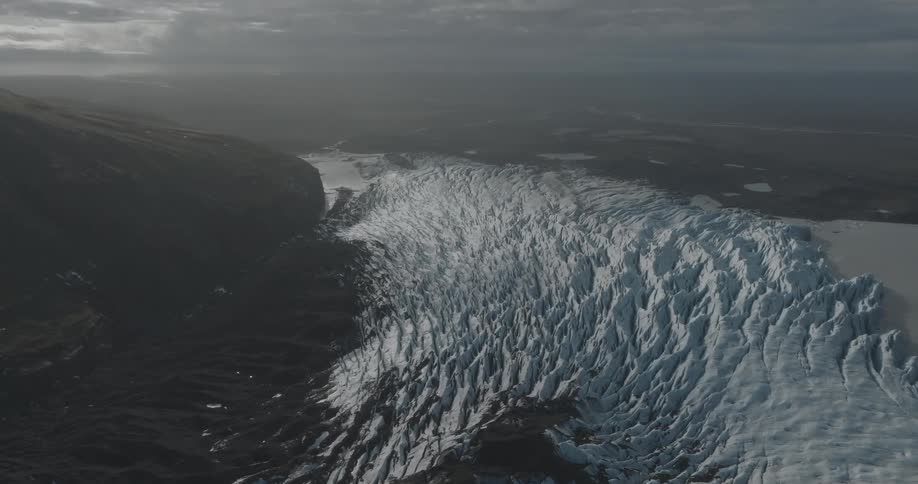 Aerial view of a glacier next to a mountain at morning