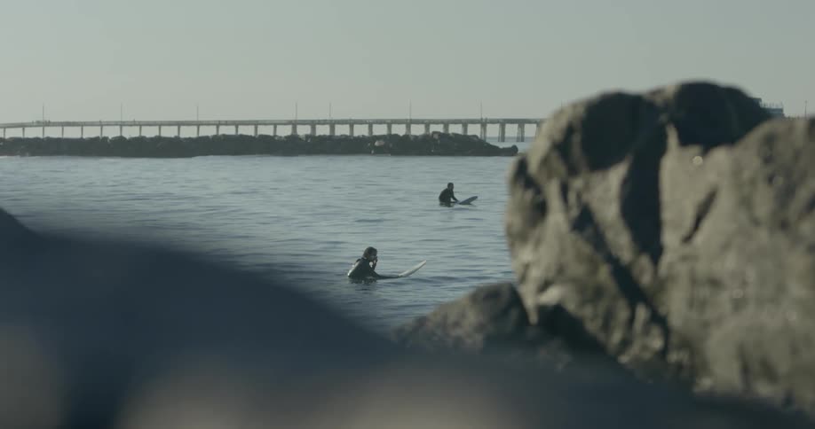 People are on surfboards in the water