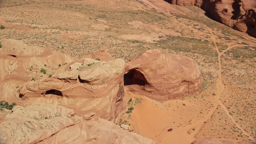 Aerial view of a natural rock arch in the badlands at daytime