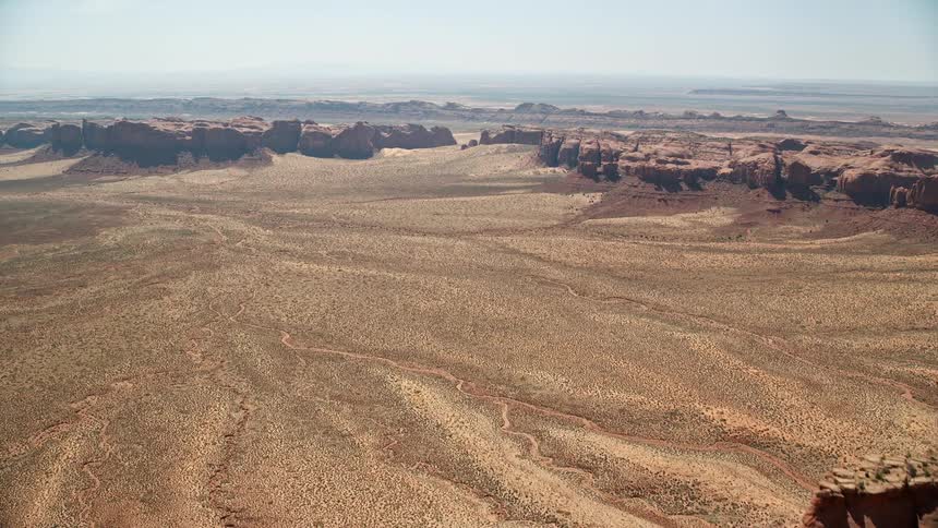 Aerial view of desert plateau with valley and a rocky terrain