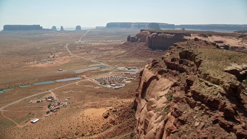 Aerial view of a valley with small house constructions and a highway next to it