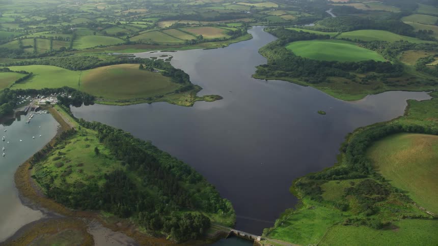 Aerial view of a river flowing through farm fields at daytime