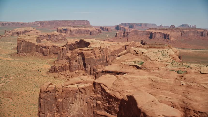 Scrub land separates plateau and mesa formations