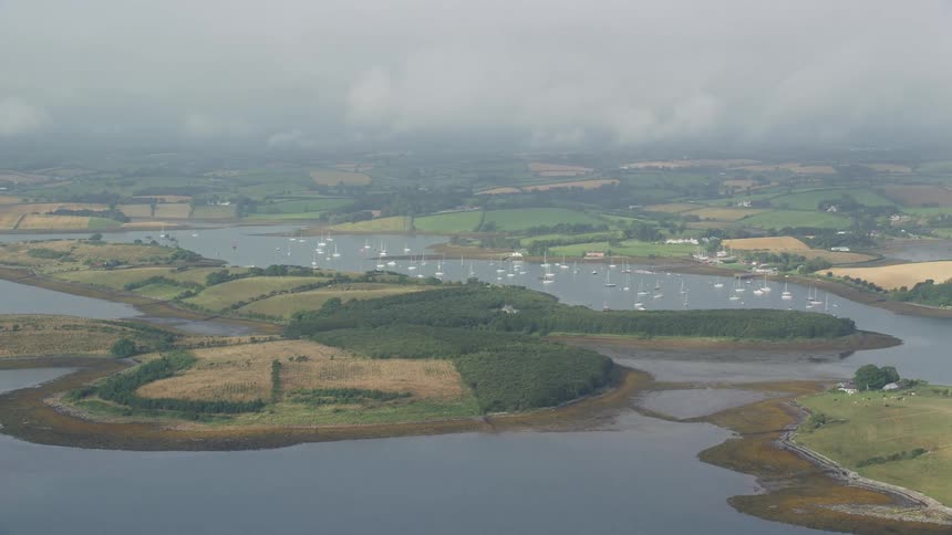 Boats on a lake surrounded by green fields