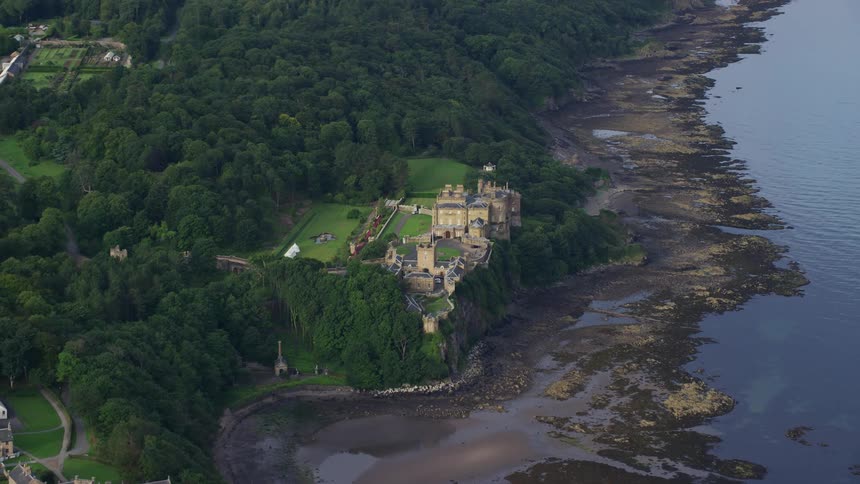 Aerial view of a stately manor in the countryside next to a river