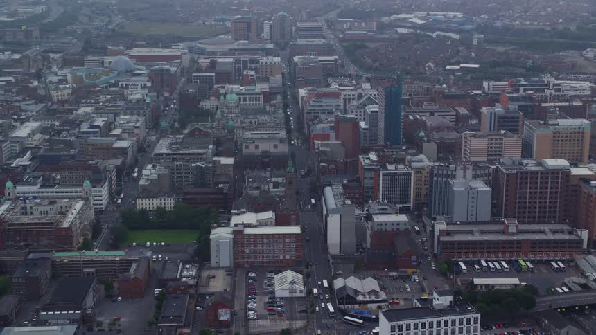 Aerial view of a metropolitan city with houses buildings streets and vehicles