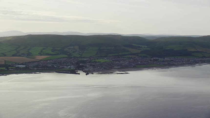An aerial view of a city on the coast of an ocena