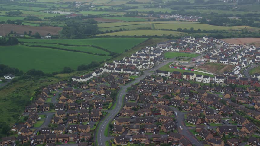 Aerial view of an urban city with agricultural fields alongside
