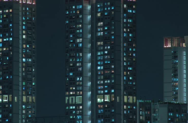 The lights glowing from several skyscraper windows go off at night